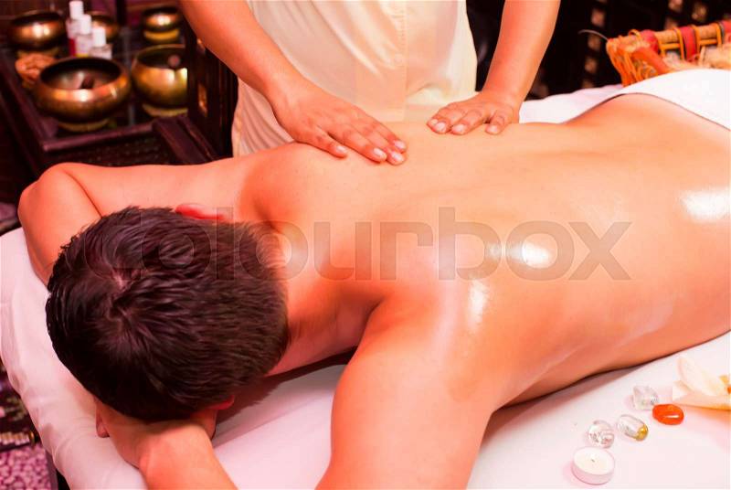 Man engaged in Ayurvedic spa treatment, stock photo