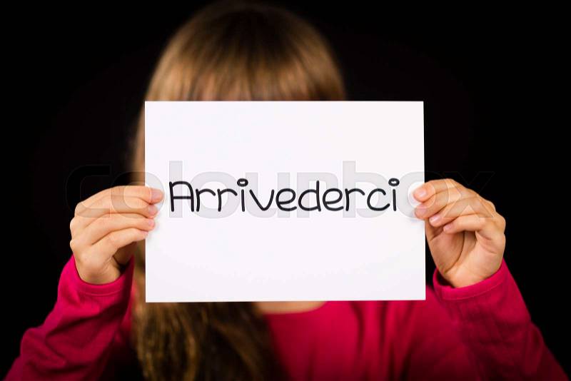 Studio shot of child holding a sign with Italian word Arrivederci - See you later, stock photo