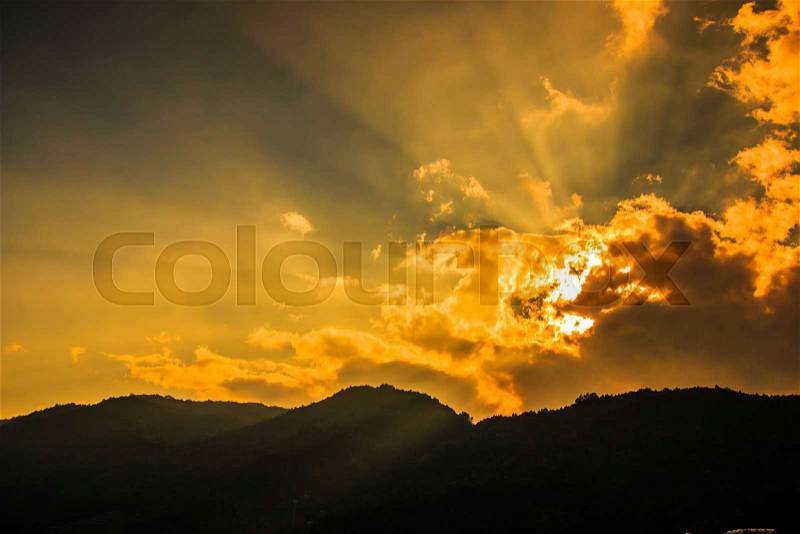 Rays of light shining through dark clouds for background, stock photo