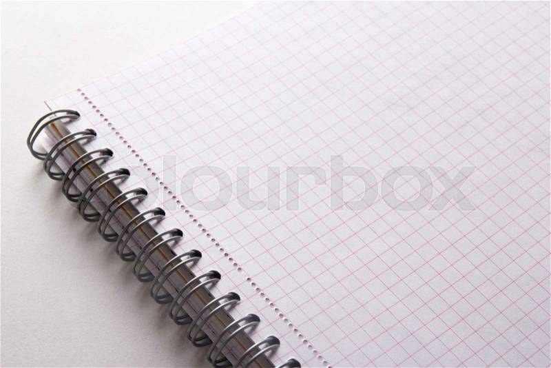 Close up of spiral note book with checked pages, stock photo