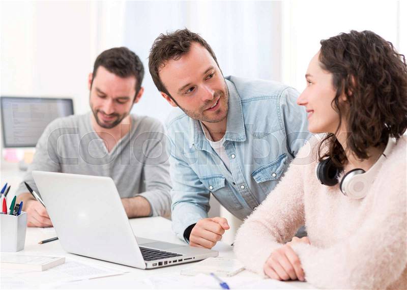 View of Students working together on a report, stock photo