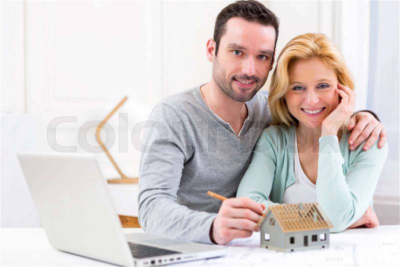 View of a Young attractive 30s couple making home project, stock photo