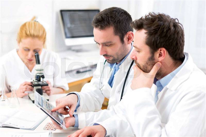 View of a Scientists team working together at the laboratory, stock photo