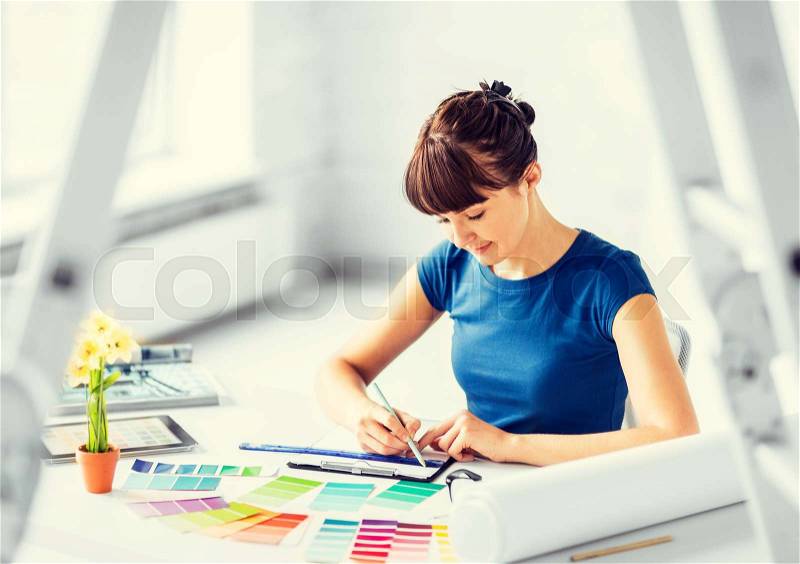 Interior design and renovation concept - woman working with color samples for selection, stock photo