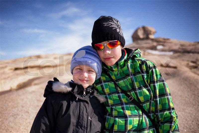 Two brothers early spring in desert mountains Bektau-Ata, Kazakhstan , stock photo