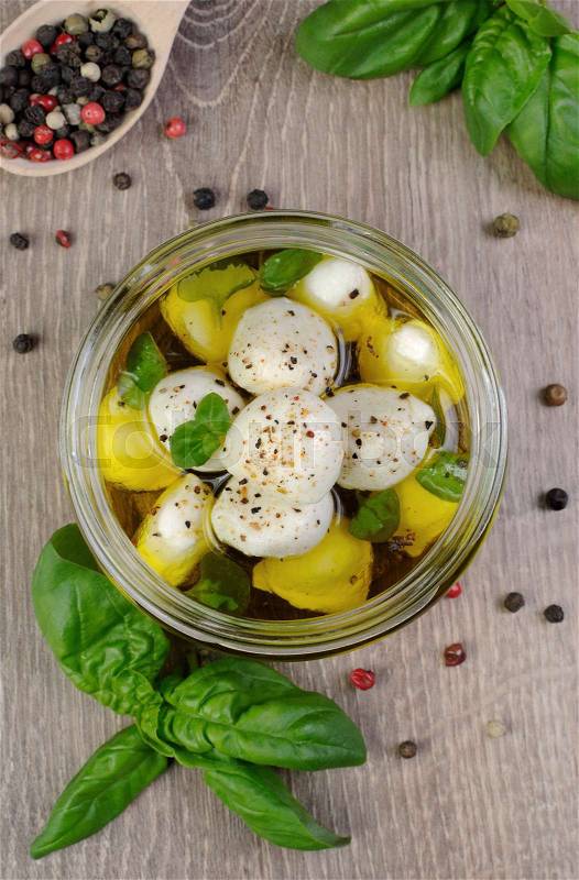 Baby mozzarella in olive oil with herbs in a glass jar | Stock Photo ...