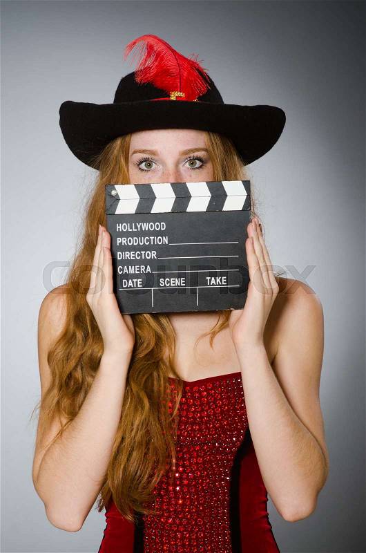 Woman in pirate costume with movie board, stock photo