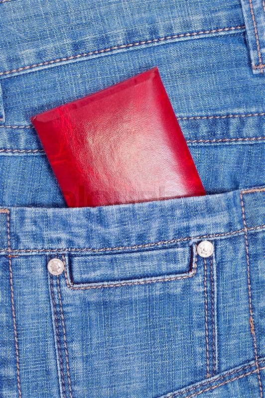 Red documents in back jeans pocket. Isolated on white, stock photo