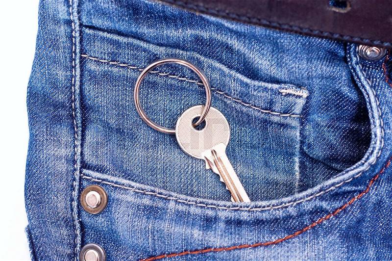 Key from house in jeans pocket, stock photo