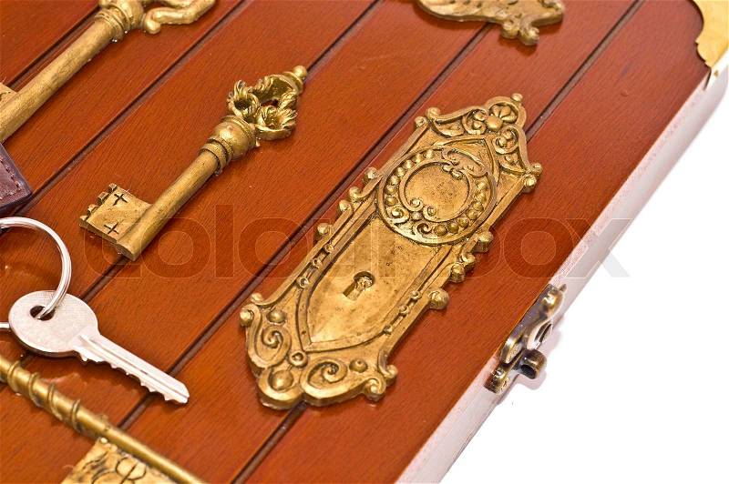 Silver key on the wooden box on white, stock photo