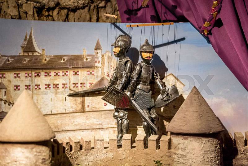 Closeup photo of puppet theater with two knights standing on tower, stock photo