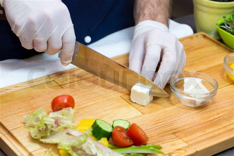 Cook prepares canapes in the kitchen at the restaurant, stock photo
