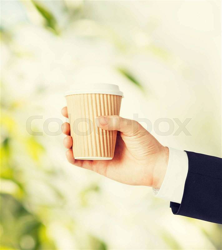Man hand holding take away coffee cup, stock photo