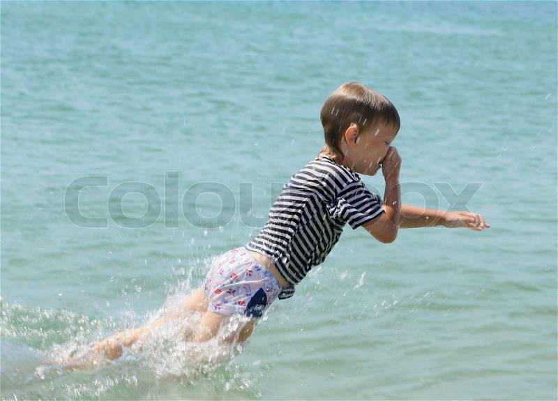 The small child jumps in water, stock photo