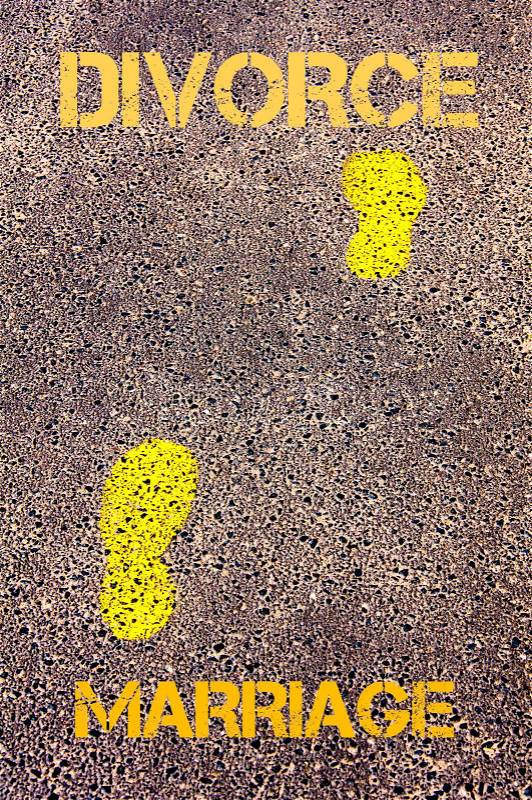 Yellow footsteps on sidewalk from Marriage to Divorce message. Conceptual image, stock photo