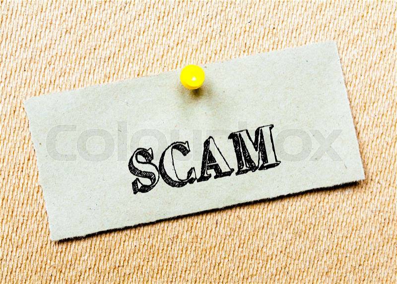Recycled paper note pinned on cork board. Scam Message. Concept Image, stock photo