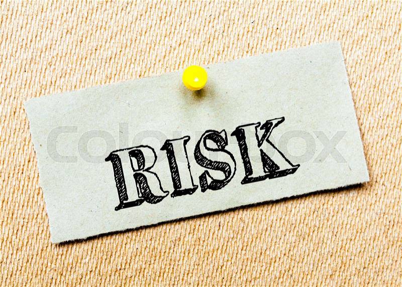 Recycled paper note pinned on cork board. Risk Message. Concept Image, stock photo