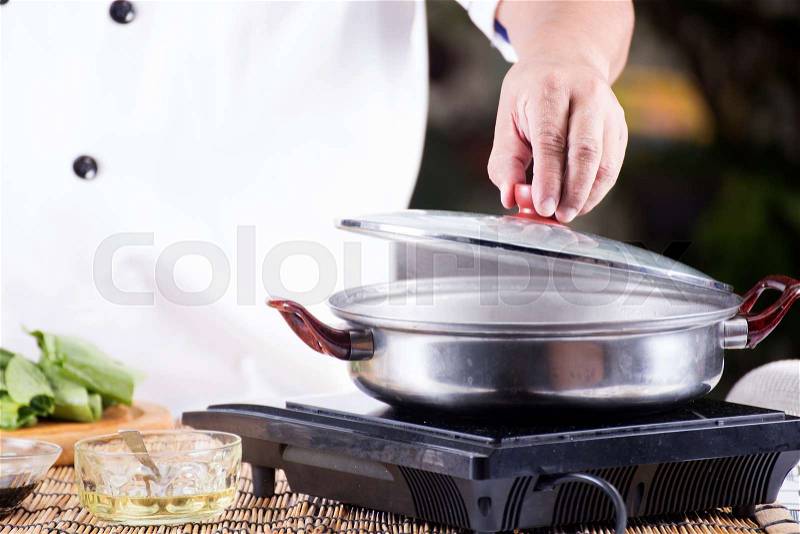 Chef opening the lid of pot before cooking noodle / Cooking Noodle concept, stock photo