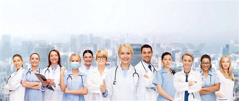 Medicine and healthcare concept - team or group of doctors and nurses showing thumbs up, stock photo