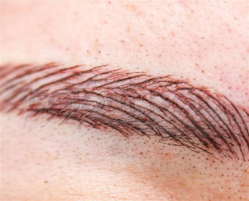 Permanent eyebrow tattoo - permanent make up on eyebrows, stock photo