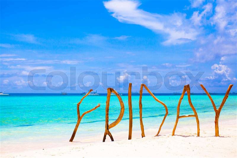 Perfect white sandy beach and turquoise sea on tropical island with wooden letters made Friday word, stock photo