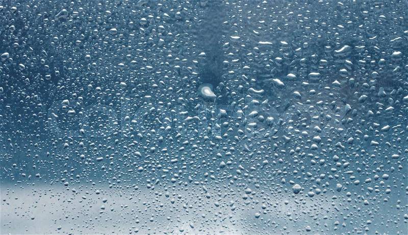 Drops of rain on the inclined window (glass), stock photo