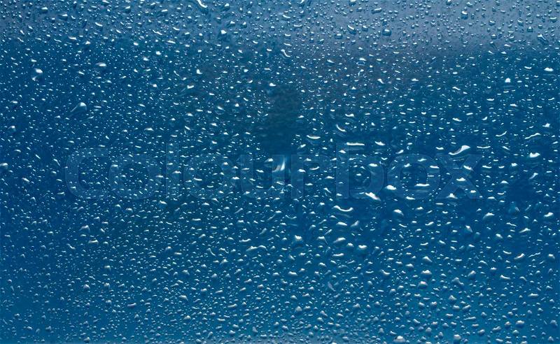 Drops of rain on the inclined window (glass), stock photo