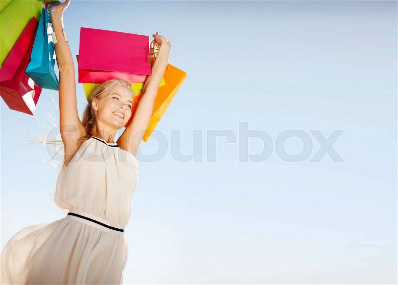 Shopping and tourism concept - woman with shopping bags, stock photo