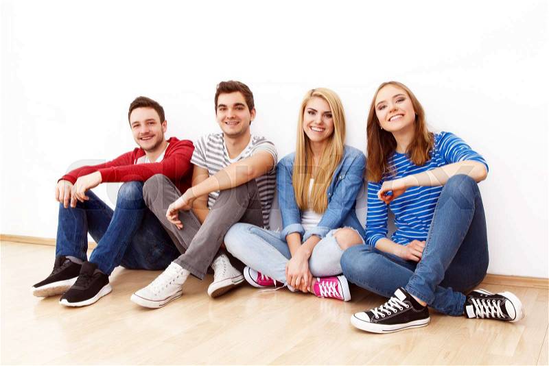 Group of four young people indoors, stock photo