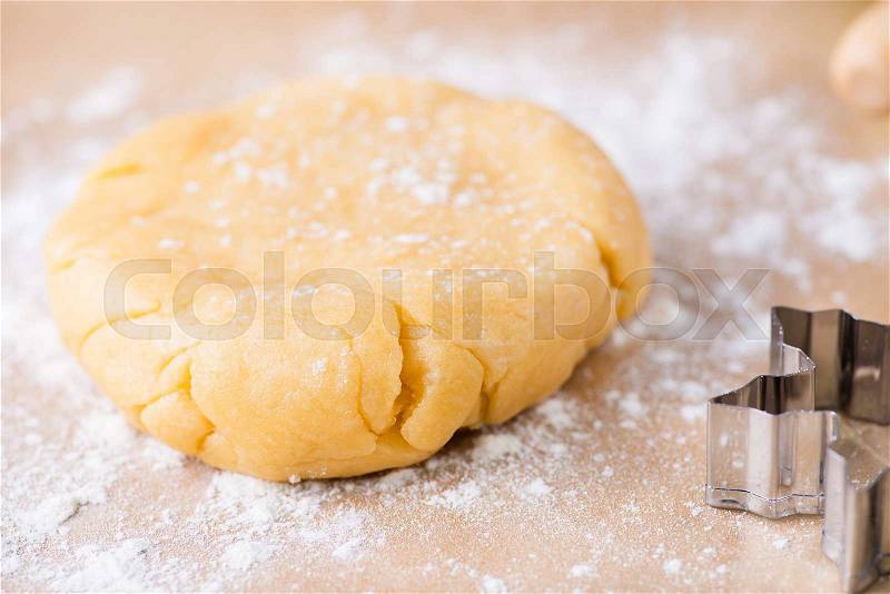 Shortcrust pastry dough, unrolled and unbaked on a floured surface, closeup, selective focus, stock photo