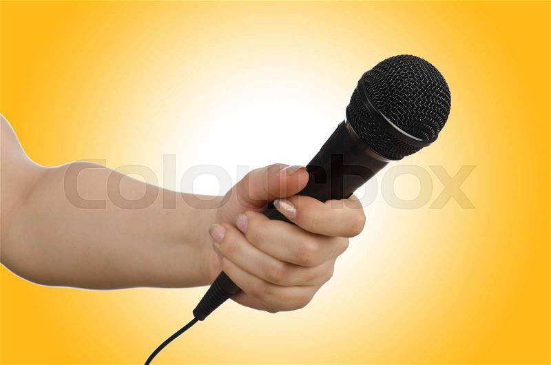 Hand with microphone on white, stock photo