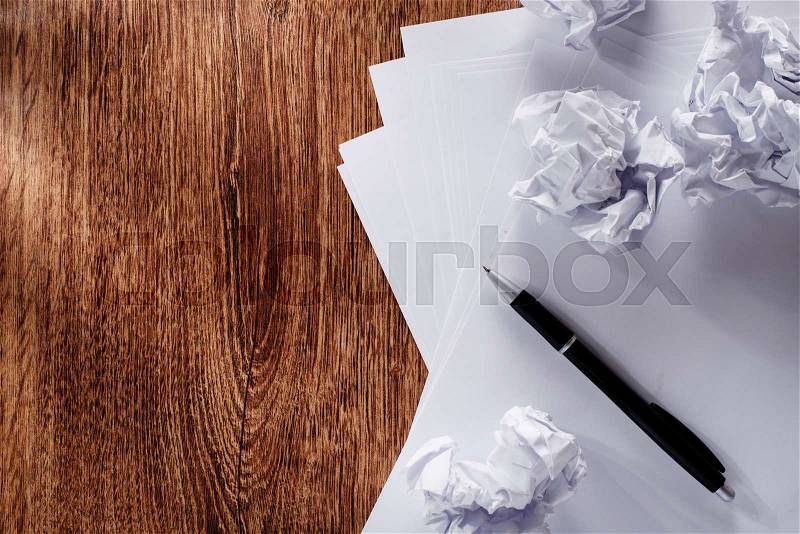 Close up Blank White Documents and Crumpled Papers with Black Pen on Wooden Table with Copy Space on the Left Side, stock photo
