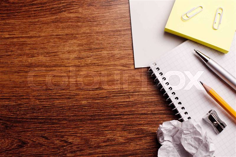 Conceptual Office or Educational Supplies on Top of Wooden Table with Text Area on Left Side, stock photo