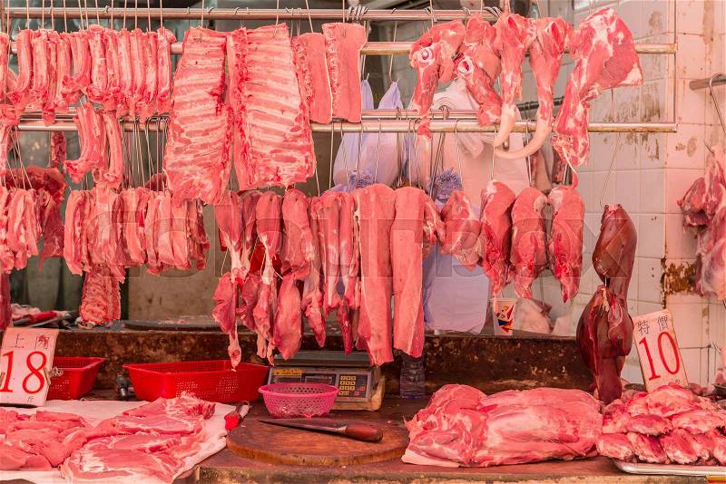 Fresh meat hanging in a butcher shop - Hong Kong, stock photo