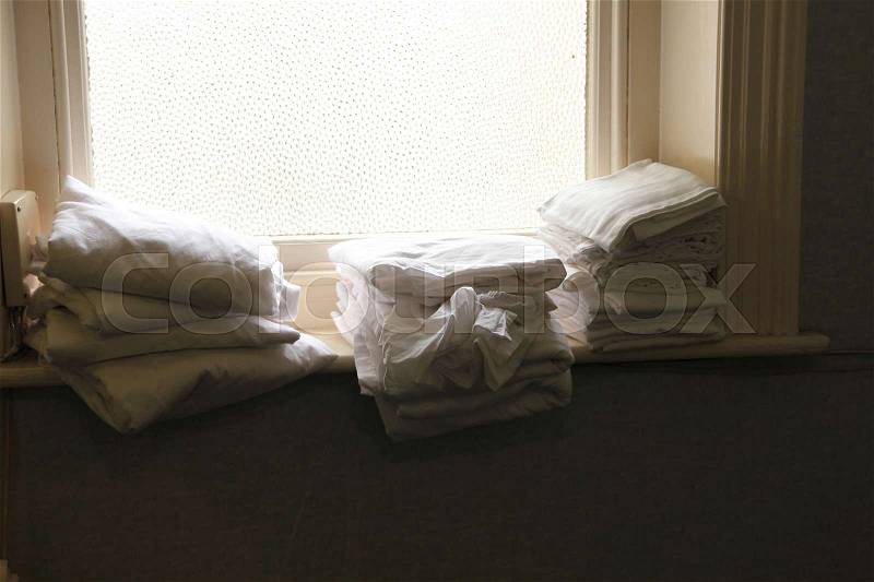 White clean bedclothes in the window sill in the Wessex Hotel in Bournemouth in England in the summer, stock photo
