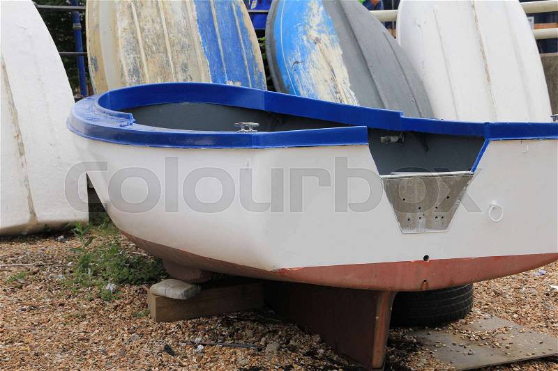 The not finished boat in paint is on the working place in the harbour in the summer in England, stock photo