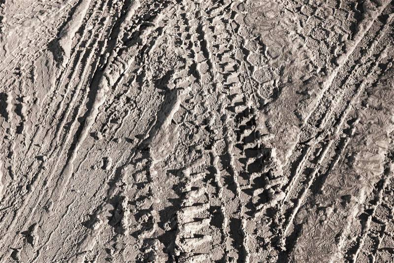 Background texture of brown road dirt with tire tracks , stock photo