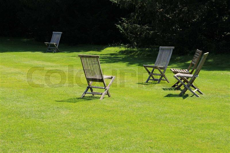 Folding chairs in the garden of the University in Oxford in England in the summer, stock photo