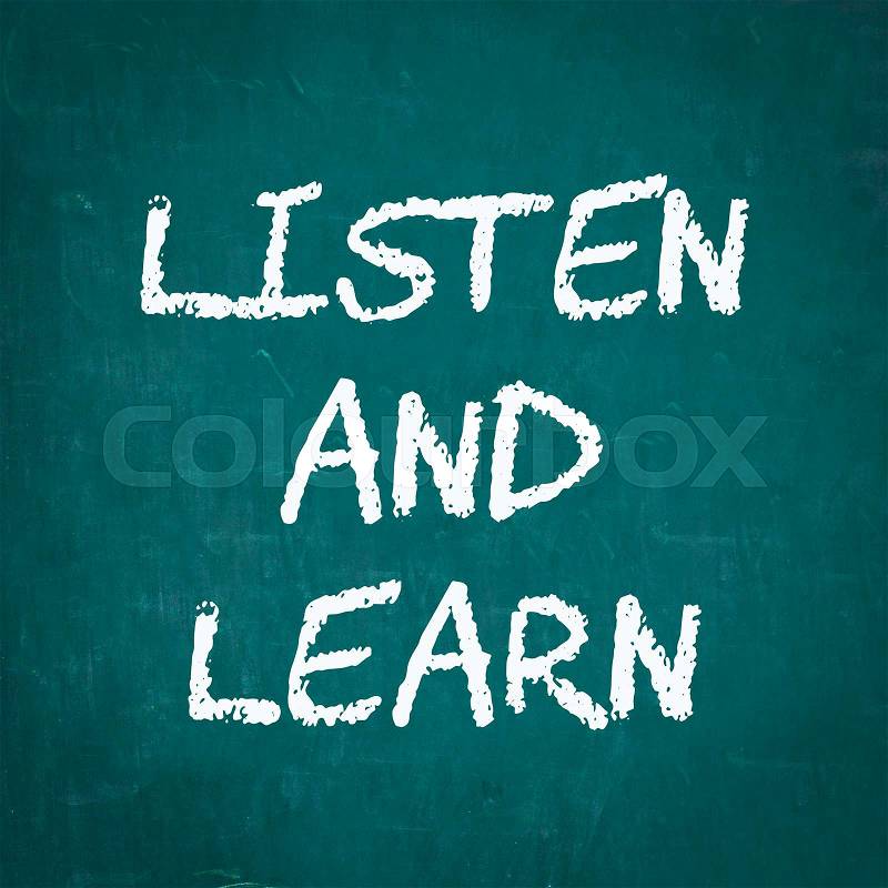 LISTEN AND LEARN written on chalkboard, stock photo