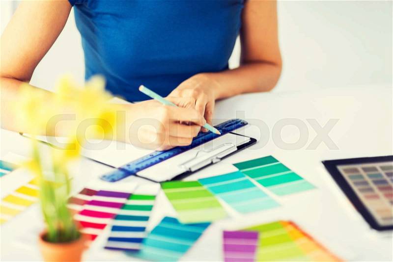 Interior design and renovation concept - woman working with color samples for selection, stock photo