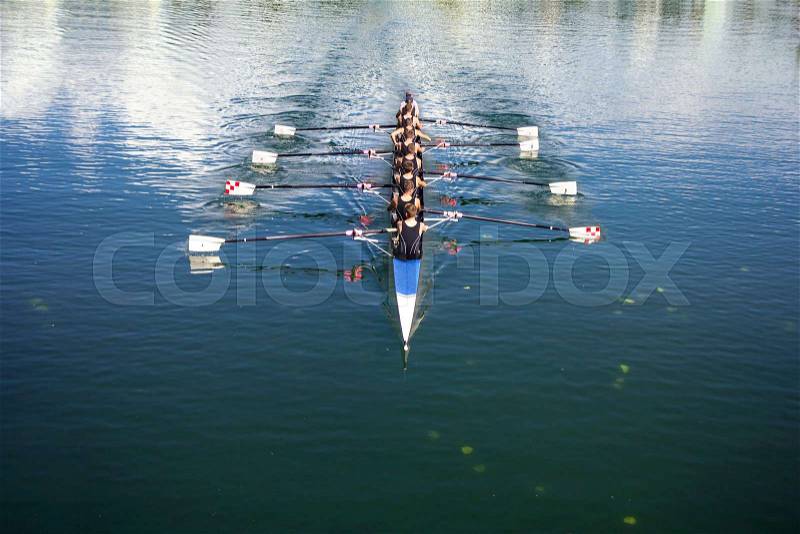 Boat coxed eight Rowers rowing on the tranquil lake, stock photo