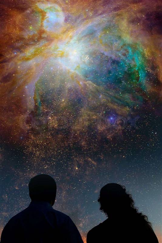Silhouettes of couple looking at stars. Starry night sky with colorful galaxies, astronomical background with place for your text.Elements of this image furnished by NASA, stock photo