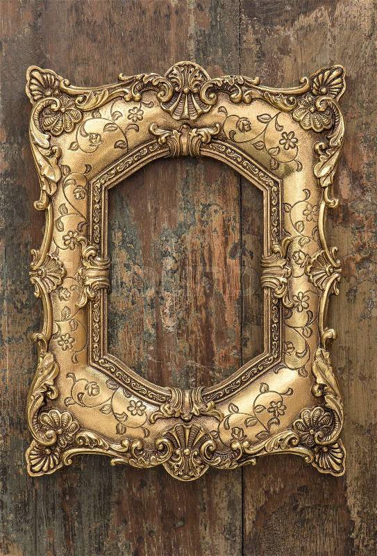 Vintage golden frame on wooden background. Grunge wood texture, stock photo