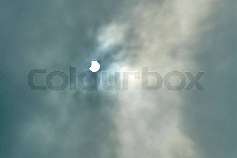 End and Partial Solar Eclipse on a Cloudy Day in Brussels on 20 march 2015, stock photo