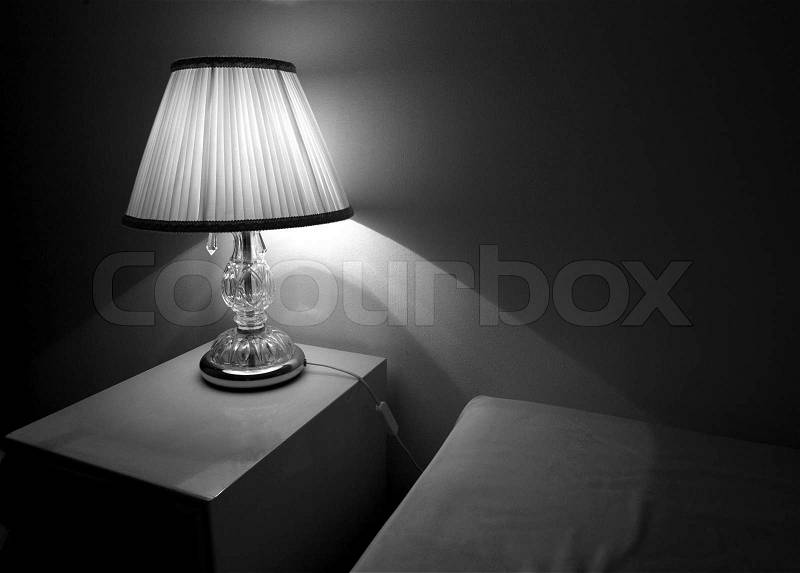 Lamp in an hotel room. The lamp is on the night table, stock photo