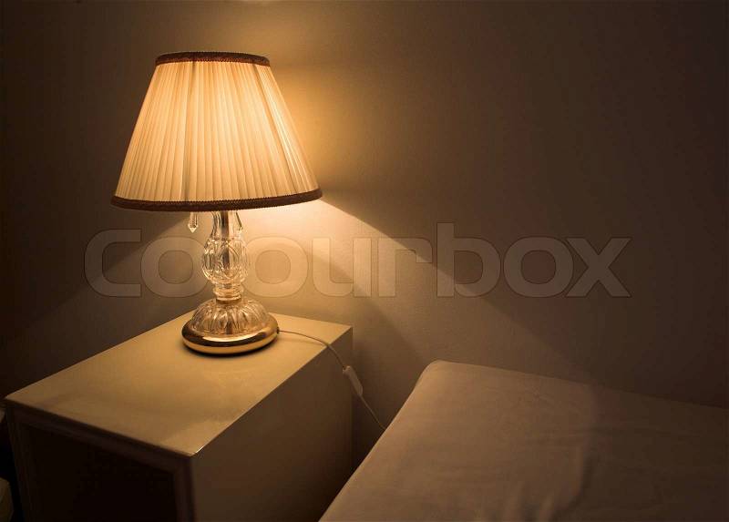 Lamp in an hotel room. The lamp is on the night table, stock photo