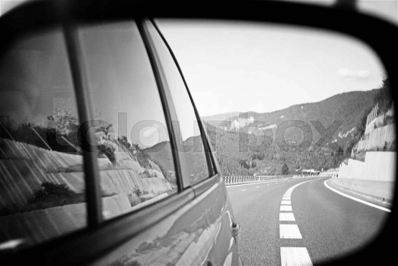 Highway viewed in car mirror, stock photo