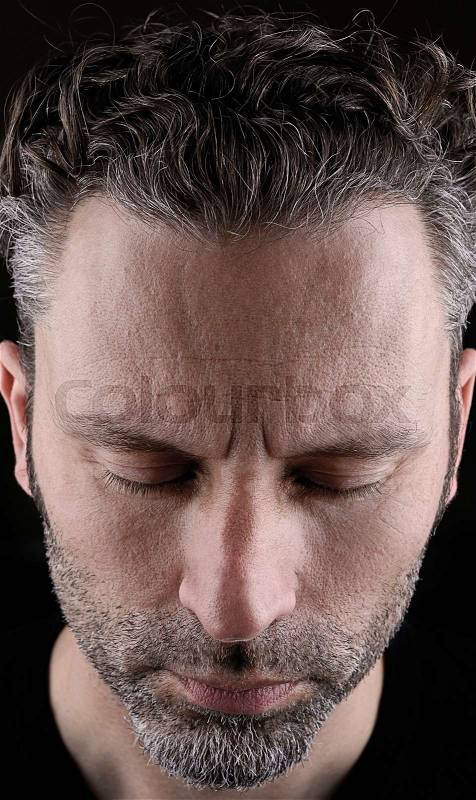 Thinking man with closed eyes, stock photo