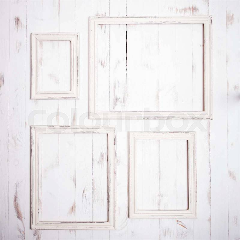Shabby chic white frames on wooden wall, stock photo