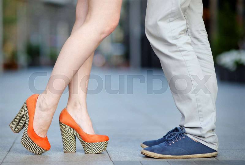Closeup photo of male and female legs during a date, stock photo